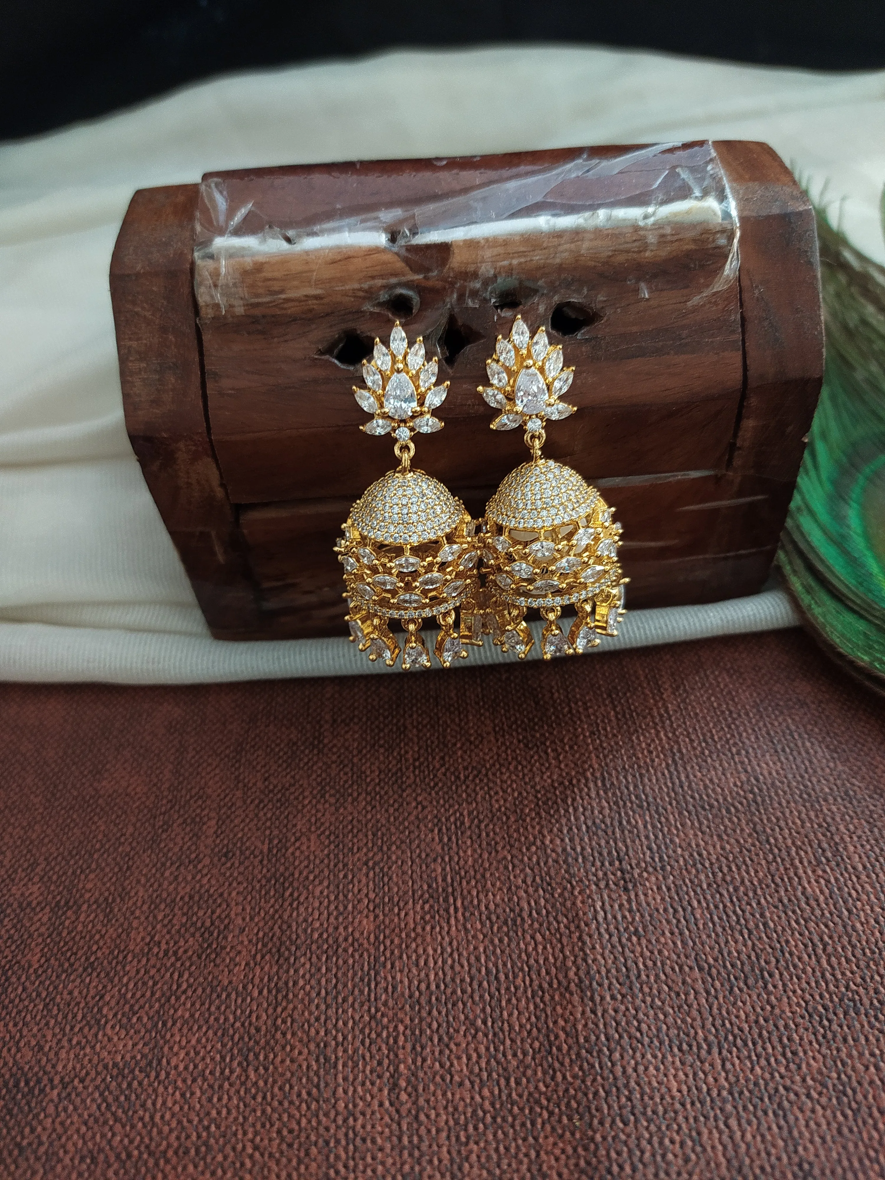 Eye Catching Gold Plated Jhumka With Zircon Stones With pearl Dangling